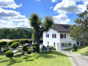 a white house with a tree in the yard at Armanaga in Ainharp