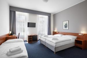 Posteľ alebo postele v izbe v ubytovaní Hotel Beránek