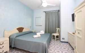 a bedroom with a bed with two towels on it at Cala Dell'Arena in Macari +37 photos