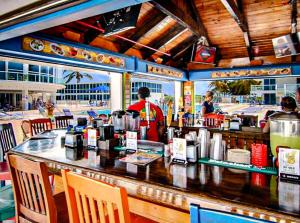 a bar in a restaurant with people in the background at Castle 1029 Balcony studio with Ocean View, Pool, Tennis and Free Parking in Miami Beach