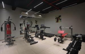 a gym with many exercise equipment in a room at juSTa Rudra Resort & Spa in Kolād