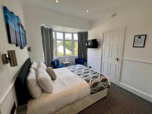 a bedroom with a large bed and a window at Charnwood Regency Guest House in Loughborough +59 photos