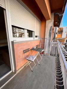 a balcony with two chairs and a table on it at Apartment City in Tivat