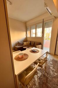 a living room with a table and a couch at Apartment City in Tivat