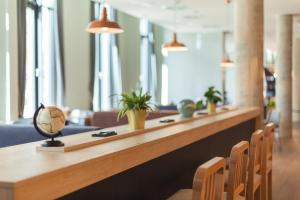 a long counter in a room with chairs at Holiday Inn - the niu, Yen Hamburg City by IHG in Hamburg