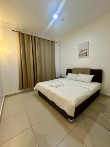 a bedroom with a large bed in a room at Homely 3-bedroom Apartment at Victoria Place in Dar es Salaam +14 photos