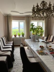 a dining room with a long table and chairs at Gulnara guesthouse in Kochkorka