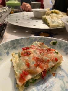 a slice of pizza on a plate on a table at Gulnara guesthouse in Kochkorka