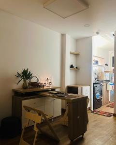 a kitchen with a desk and a chair in a room at Tom's Homestay in Ho Chi Minh City