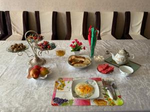 a table with breakfast foods and drinks on it at Gulnara guesthouse in Kochkorka