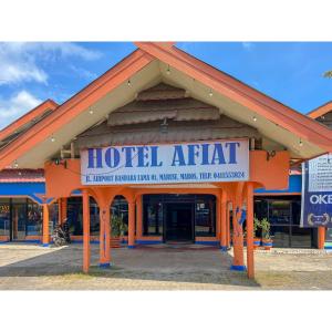 a hotel entrance with a sign that reads hotel artifact at Afiat Hotel Maros Makassar RedPartner in Makassar