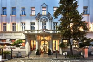 a large white building with a clock on it at H15 Boutique Hotel, Warsaw, a Member of Design Hotels in Warsaw