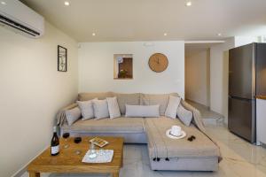 a living room with a couch and a table at Nicolas Urban Luxury Living in Souda
