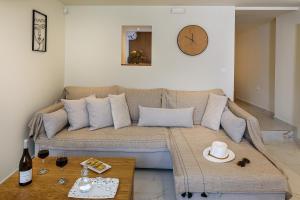 a living room with a couch and a clock on the wall at Nicolas Urban Luxury Living in Souda +30 photos