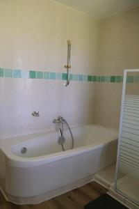 a bath tub with a faucet in a bathroom at les portes des Froises in Saint-Quentin-en-Tourmont