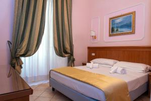 a bedroom with a bed and a window at Hotel Philia in Rome