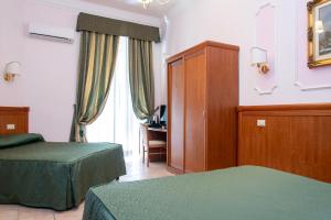 Postel nebo postele na pokoji v ubytování Hotel Philia