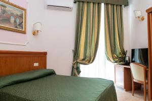 Postel nebo postele na pokoji v ubytování Hotel Philia