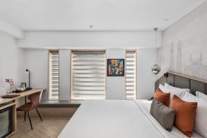 a bedroom with a large bed and a desk at Hotel Suncity Residency in Mumbai