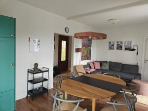 a living room with a table and a couch at Casa Alla Vigna - Lugano in Pregassona