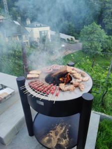 a barbecue grill with meat and other foods on it at Casa Alla Vigna - Lugano in Pregassona