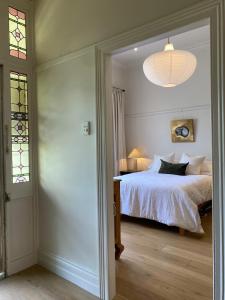 a bedroom with a bed and a window and a lamp at Eyre House Ballarat in Wendouree