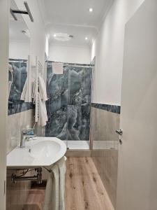 a bathroom with a sink and a shower at Andreola Central Hotel in Milan