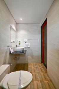 a bathroom with a sink and a toilet in it at HOTEL SHITAL INN in Ahmedabad