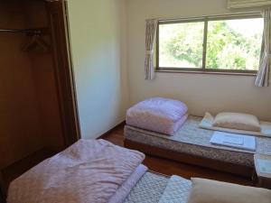 Postel nebo postele na pokoji v ubytování Farm Inn Minamiboso