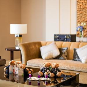 a living room with teddy bears on a coffee table at The St. Regis Chengdu in Chengdu