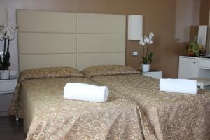 Postel nebo postele na pokoji v ubytování Hotel Regit