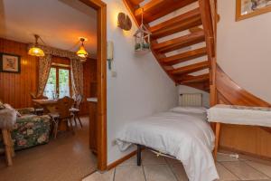 a bedroom with a staircase and a bed in a room at Lodge Auta in Falcade