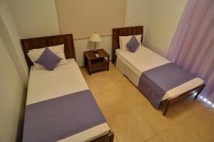 Postel nebo postele na pokoji v ubytování Aphrodite Sands Resort