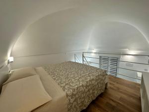a bedroom with a bed in a white room at Hary Home in Brindisi