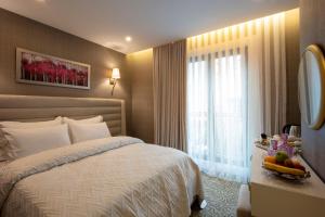 a hotel room with a bed and a window at Mr Beyaz Hotel Sisli Istanbul in Istanbul