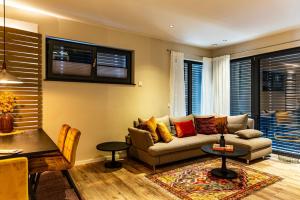 a living room with a couch and a table at vineLodge L in Maikammer