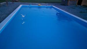 an empty swimming pool with blue water at OPG VIDA in Garešnica