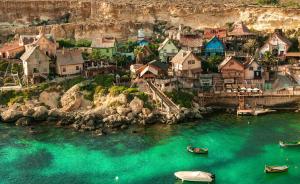 a group of houses and boats in the water at Mellieha, Charming 2 Bedroom Apartment Santa Maria Heights Mellieha in Mellieħa