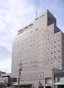 a large white building with a sign on it at Kofu Washington Hotel Plaza in Kofu