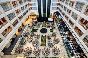 an overhead view of a building with tables and chairs at Embassy Suites by Hilton Atlanta Buckhead in Atlanta