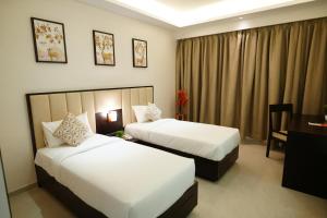 Postel nebo postele na pokoji v ubytování Hotel Grand Visava Lonavala + 37 fotografií