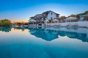 a pool of water in front of a hotel at Hamarat Otel in Kaş
