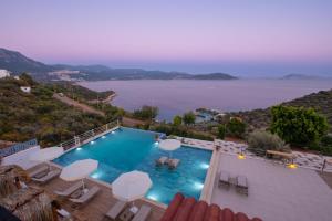 a swimming pool with a view of the water at Hamarat Otel in Kaş +37 photos