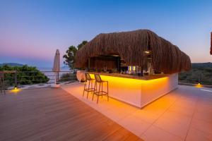 a bar on the roof of a resort with a view at Hamarat Otel in Kaş