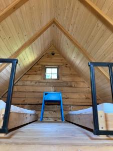 a room with a blue table in a attic at Domek Samice in Samice