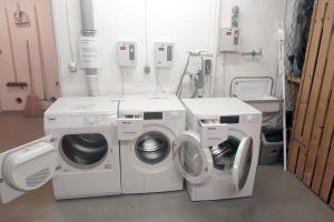 two washing machines in a laundry room in a hospital at Ohl Doerp 22 Pastoratshof_ Haus 3 in Wrixum