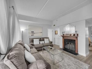 a living room with a couch and a fireplace at Uhost AI - 2BR 2BA Suite with Balcony - 6 Sleeps in Sugar Mountain