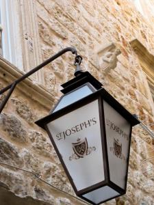 a street light on the side of a building at St. Joseph's in Dubrovnik