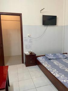 Postel nebo postele na pokoji v ubytování Nhà Nghỉ Mỹ Linh 5
