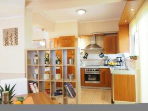 a kitchen with wooden cabinets and a stove top oven at Niko's art Villa in Chania in Perivólia
